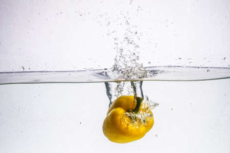 three peppers falling in water. nature, organic, paprica,の写真素材