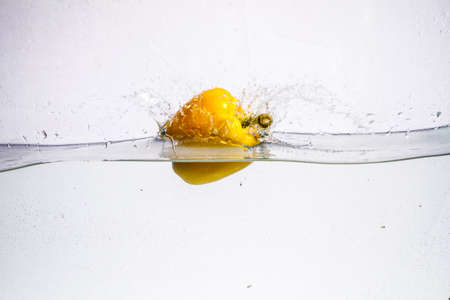 three peppers falling in water. nature, organic, paprica,の写真素材
