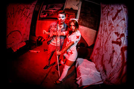 KHARKIV, UKRAINE - OCTOBER 26, 2019: Crazy dead nurse with knife in the hand in a dark roomのeditorial素材