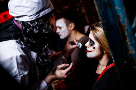 Ukraine, October 26, 2019: Makeup of a scary doll with blood from the eyes and on the neck on the girl's face on Halloween.のeditorial素材