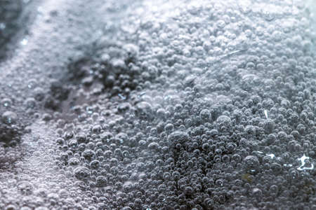 Boiling foam in a saucepan on an electric stoveの写真素材