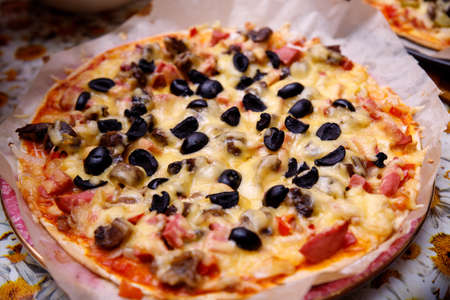 Overhead shot of friends at a table sharing take-away pizzasの写真素材