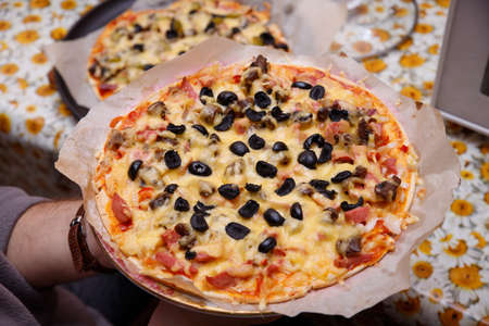 Overhead shot of friends at a table sharing take-away pizzasの写真素材