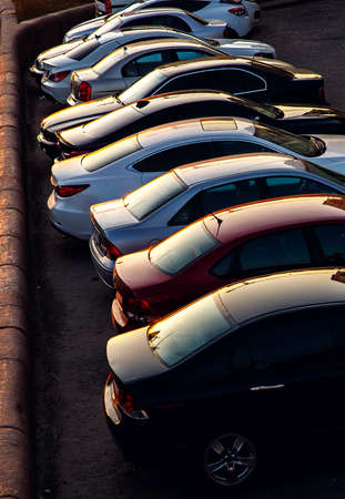 Car parked at concrete parking lot of shopping mall in holiday. Aerial view of car parking area of the mall. Automotive industry. Automobile parking space. Global automobile market concept.の写真素材
