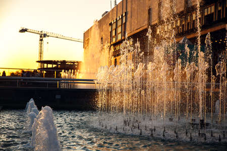 Fountain in the public city park. Sunset in summer.の写真素材