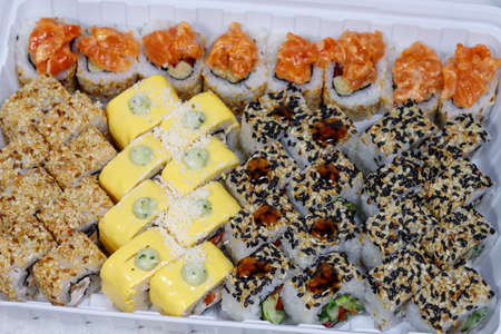Sushi and rolls home delivery. Krpny plan. Sesame, salmon, cheese.の写真素材