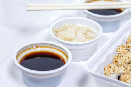 soy sauce in a disposable bowl on a white backgroundの写真素材