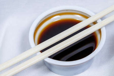 soy sauce in a disposable bowl on a white backgroundの写真素材