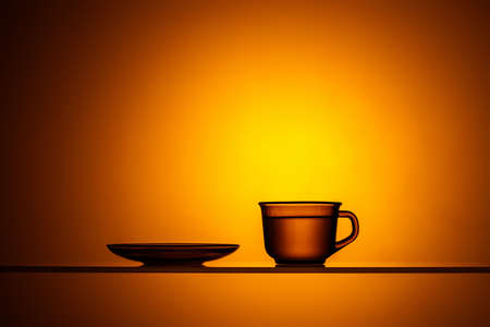 Cup of hot tea on a yellow backgroundの写真素材
