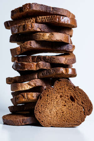 The texture of toasted pieces of bread. Croutons on a white background. Dark dry bread.の写真素材
