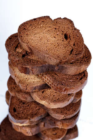 The texture of toasted pieces of bread. Croutons on a white background. Dark dry bread.の写真素材
