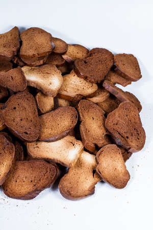 The texture of toasted pieces of bread. Croutons on a white background. Dark dry bread.の写真素材