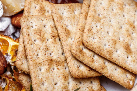 delicious wheat flour cookies and chocolate drops inside the prepared shortbread dough, homemade cookies of irregular round or oval shape, closeupの写真素材