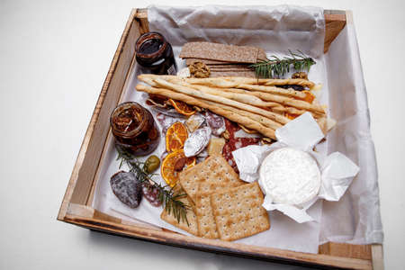 Catering. Snacks and goodies. Scrap delivery set. Jam, biscuits, sausage, cheese, orange and moreの写真素材