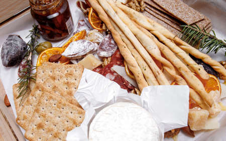 Catering. Snacks and goodies. Scrap delivery set. Jam, biscuits, sausage, cheese, orange and moreの写真素材