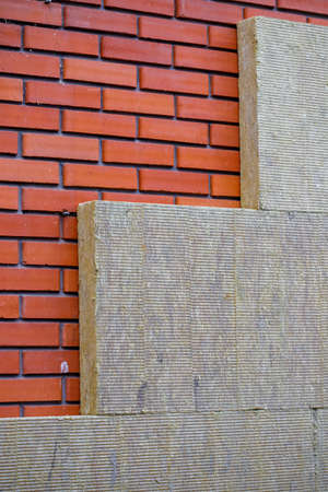Thermal insulation material, rock wool. Thermal roof insulation layer. Mineral wool or mineral fiber, mineral cotton, mineral fibre, glass wool, MMMF, MMVF. Fiber thermal insulation close-up.の写真素材