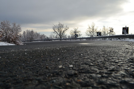 The road is covered with ice and snow in winter in the eveningの写真素材