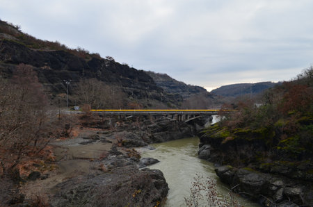 Old bridge over the river in the mountains. View from above.の写真素材