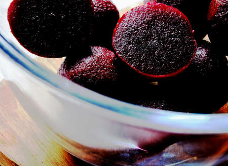 Pickled whole and sliced beetroot in the glass bowl