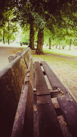 An old wooden bench in the park areaの写真素材