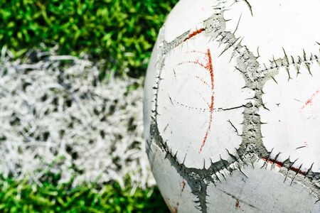 Old soccer ball on green grassの写真素材