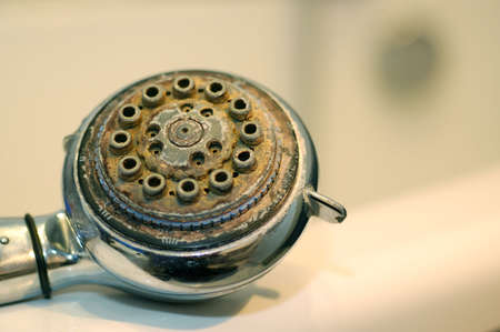 Damaged shower head with ground limestones.の写真素材