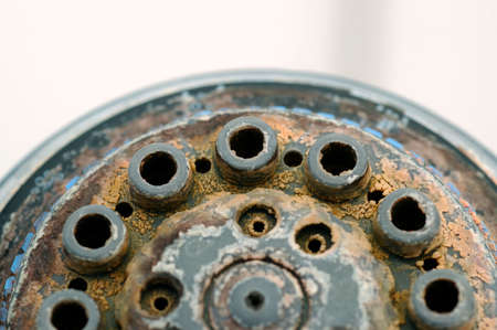 Damaged shower head with ground limestones.の写真素材