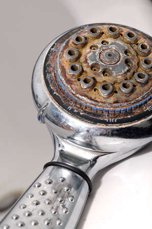 Damaged shower head with ground limestones.の写真素材