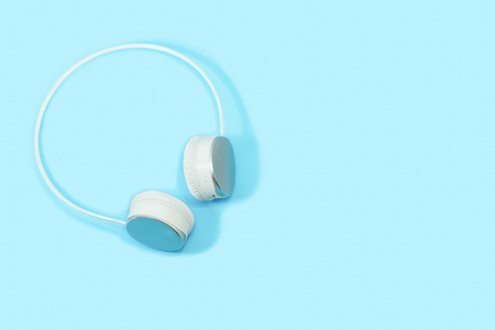 Wireless headphones isolated on light blue background.の写真素材