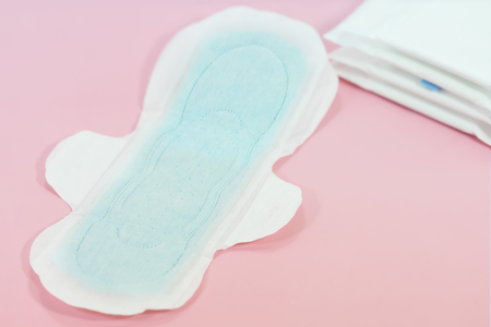 Sanitary pads and absorbent sheets on a pink backgroundの写真素材