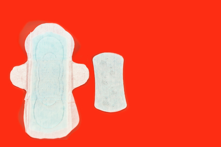 Sanitary pads and absorbent sheets on a red backgroundの写真素材