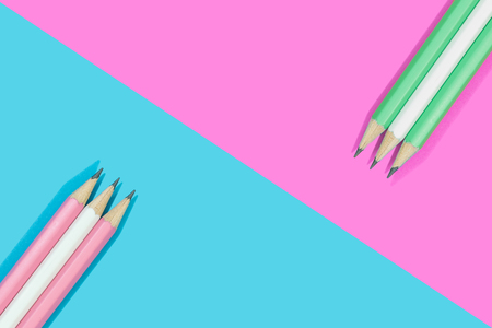 Pencils of pink, white and green on blue and pink background.  Concept education stationery.の写真素材