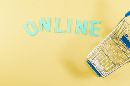 Concept shopping online with trolley on yellow for backgroundの写真素材