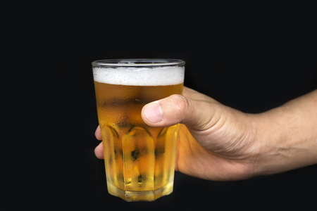Beer in a glass on isolated black background