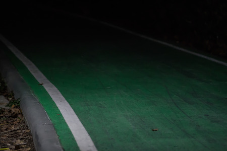 Road for biking in the park in the darkの写真素材