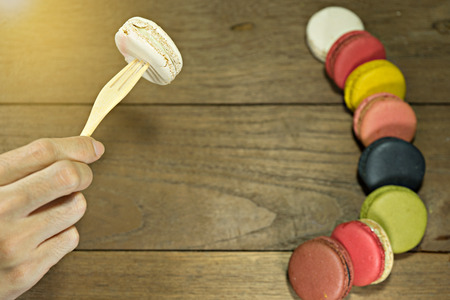 Macaroon on wooden with handの写真素材