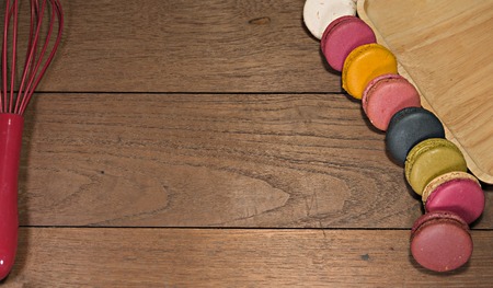 Colorful macaroons on wooden table. Sweet macaroons. Top view with copy space for your textの写真素材