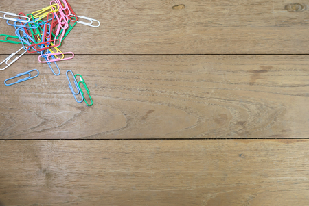 Paper clips on wooden table.の写真素材