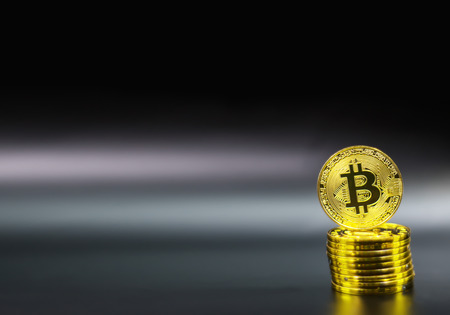 Gold Bitcoin on black background. Concept electronic money in future.の写真素材