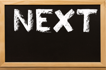 Next write by white chalk on a blackboard.の写真素材