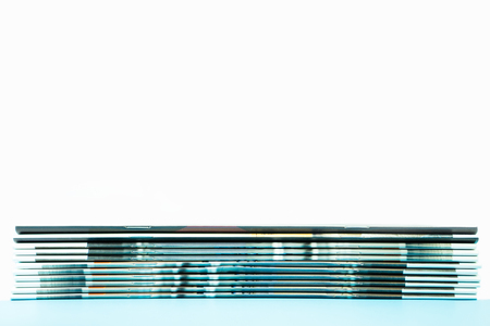 Stack of magazines on blue and white background
