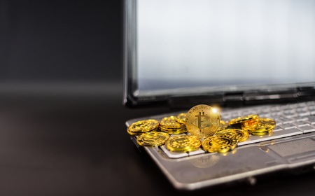 Bitcoin on laptop computer on black background.の写真素材