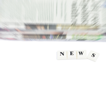 The word NEWS with abstract newspaper on white background.の写真素材