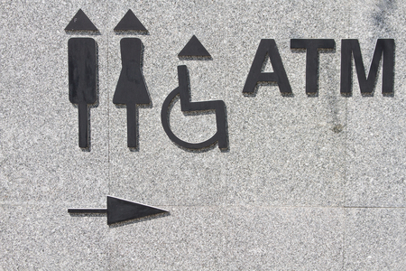 Restroom signs and ATM signs, detail of an information signの写真素材