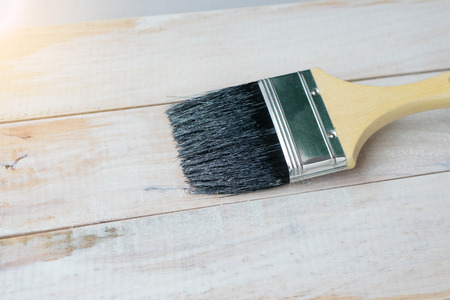 Paint with brush on wood.