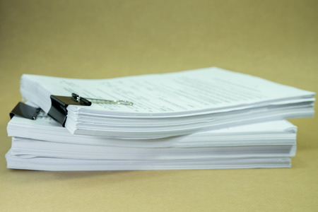 Stack documents on cardboard brown paper in concept save Earth and use paper economically and...