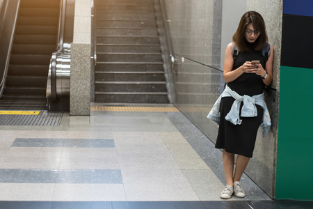 Woman traveler use smartphones to find travel maps at subway  in Bangkok.の写真素材