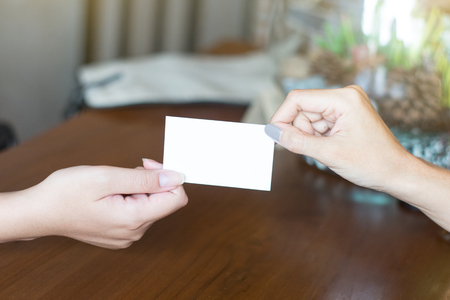 Hands of woman holding mockup name card give to connect business.  Connection concept.の写真素材