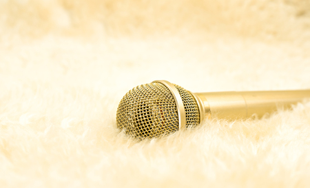 Gold microphone on wool carpet.  Luxury conceptの写真素材