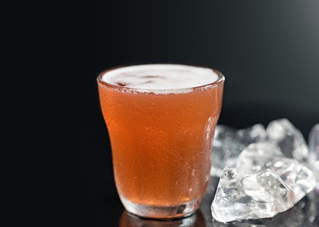 Cold drink with iced cube on black background.の写真素材